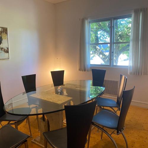 a dining room with a glass table and chairs at Johanneberg in Vordingborg