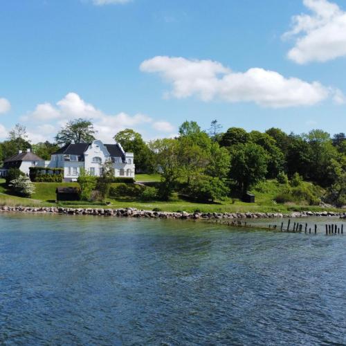 a house on the shore of a body of water at Johanneberg in Vordingborg