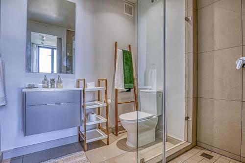 a bathroom with a toilet and a glass shower at Casa Vista One Rosebank in Johannesburg