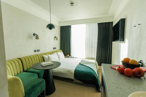 a hotel room with a bed and a couch and a table at Staycity Aparthotels London Dalston in London