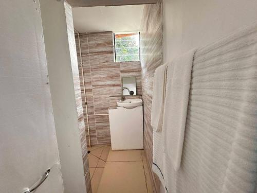 a small bathroom with a toilet and a sink at Tandra Island View Lodge 