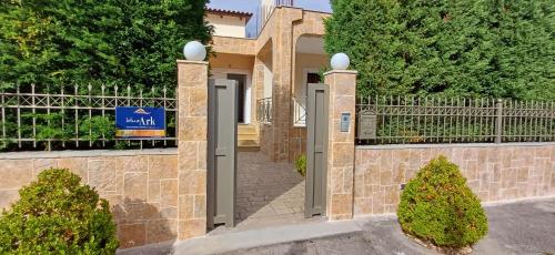 a gate to a villa with a sign on it at Blue Ark Aigeira Flat & Studio in Aíyira