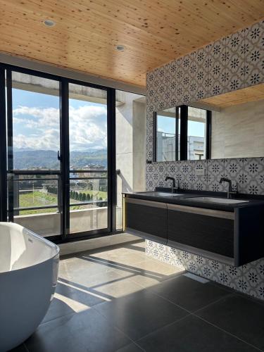 a bathroom with a tub and a large window at Find 777 B&B in Guilin