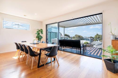 a dining room with a table and chairs at Spacious Seaview Family Getaway in Torquay