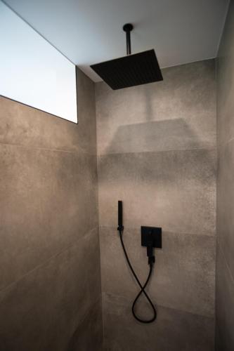 a bathroom with a shower with a light at Alpin Chalet in Bürserberg