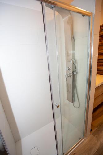 a shower with a glass door in a bathroom at Dimora 85 in Policoro