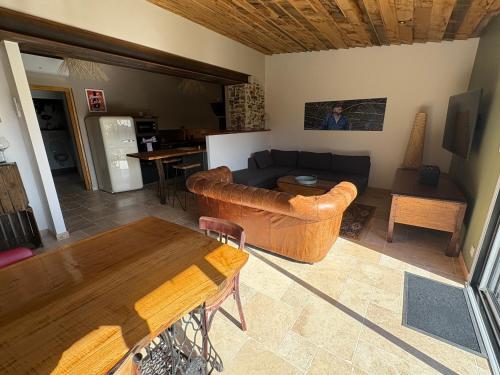 a living room with a couch and a table at Le Chai des Poilanes in Liré