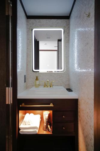a bathroom with a sink and a mirror at KIORI Exec Muromachi in Kyoto