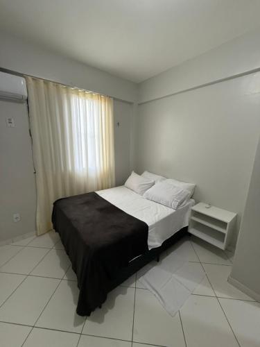 a bedroom with a bed and a window in it at Apartamento COP 30, Belém in Belém