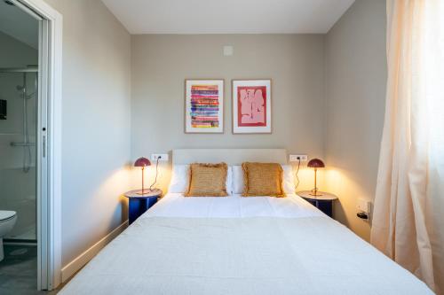 a bedroom with a large white bed with two lamps at Santa Barbara Boutique Stay in Toledo