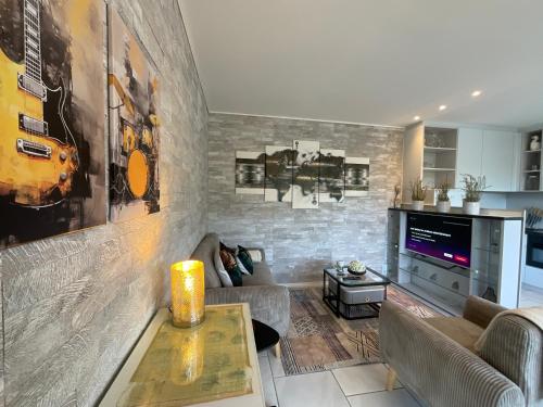 a living room with a couch and a table at Komfortappartement mit Terraasse in Wuppertal