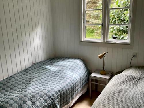 a bedroom with a bed and a window at Stunning Home In Nykøbing Sjælland W in Nykøbing Sjælland
