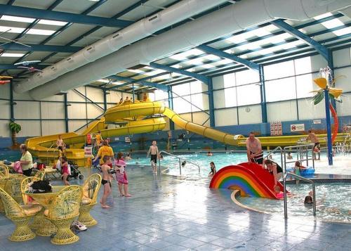 a group of children playing in a water park at Golden Palm Resort - The Ascot - Coastal Caravan Breaks in Chapel Saint Leonards
