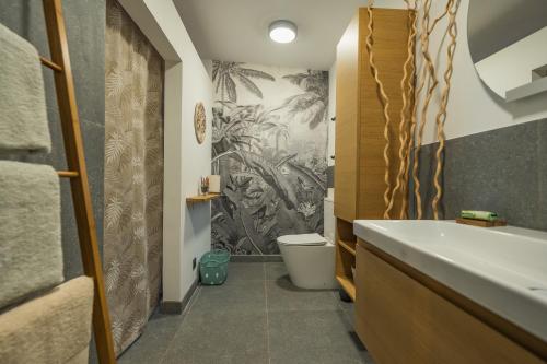 une salle de bain avec un lavabo et des toilettes dans l'établissement Azur Escale - Détente entre Mer et Montagne, à Maison Henou