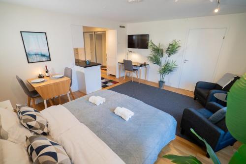 a living room with a couch and a table at Prime City Location, Spacious Studio Apartment in Gothenburg