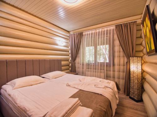 a bedroom with a bed in a room with a window at Solva Resort Medical & SPA in Polyana