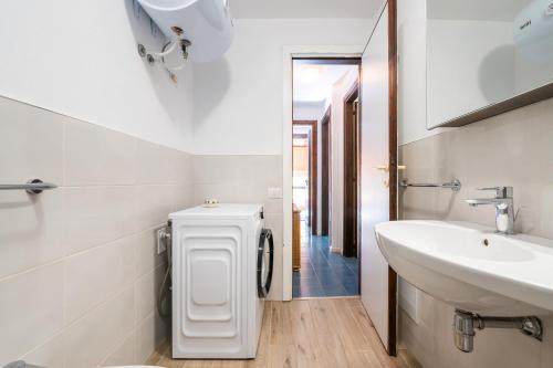 a bathroom with a white toilet and a sink at Calaverde Apartment in Fort Village