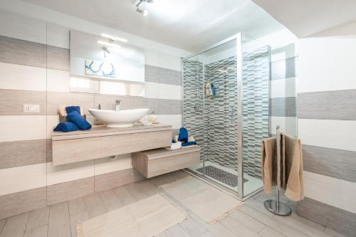 a bathroom with a sink and a glass shower at Casa Vacanze Manzoni 29 in Cagliari