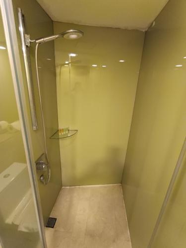 a shower with a glass door in a bathroom at KLCC Sky Villa Suites Vortex in Kuala Lumpur