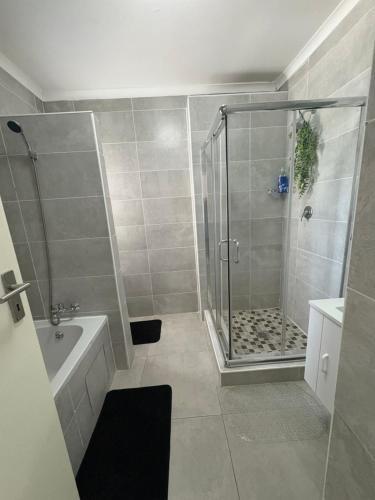 a bathroom with a shower and a sink at Haven & Beyond in Gaborone