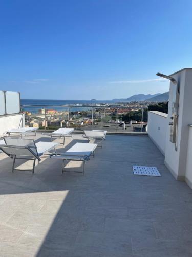 a group of tables and benches on a roof at Appartamento Sabbia e sogni in Pietra Ligure