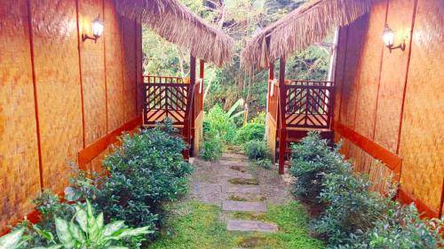 a pathway through a garden with plants in a building at Huan Kaw Fang in Mae On