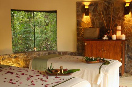 a room with two beds and a window at The Lodge & Spa at Pico Bonito in El Pino