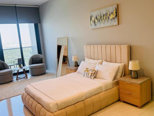 a bedroom with a large bed and a large window at Skyleaf Studio in Dubai