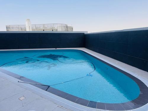 a large blue swimming pool on top of a building at Skyleaf Studio in Dubai