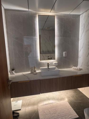 a bathroom with a sink and a mirror at Skyleaf Studio in Dubai