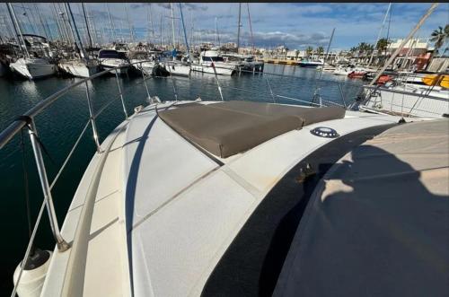 a boat is docked in a marina with other boats at Luxury experience on a 16-meter Azimut yacht in Torrevieja