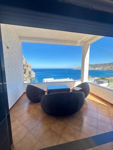 a living room with a view of the ocean at Belyounech Panorama Sea and Mountain Apartment in Belyounech 