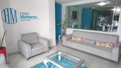 a living room with two chairs and a coffee table at Hotel Monterrey in Barranquilla