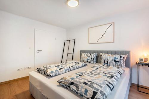 a bedroom with two beds and a picture on the wall at The Cozy Corner - Passau in Passau
