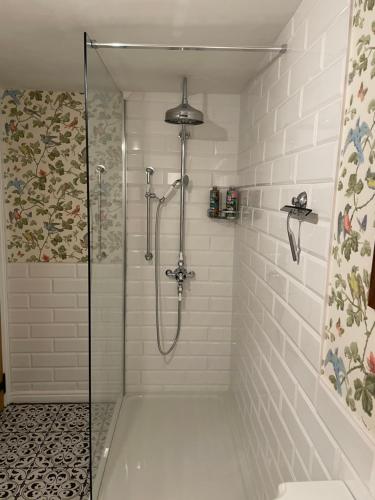 a shower with a glass door in a bathroom at The Old Scullery in Bungay