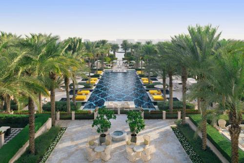an aerial view of a fountain in a resort with palm trees at One&Only The Palm Dubai in Dubai