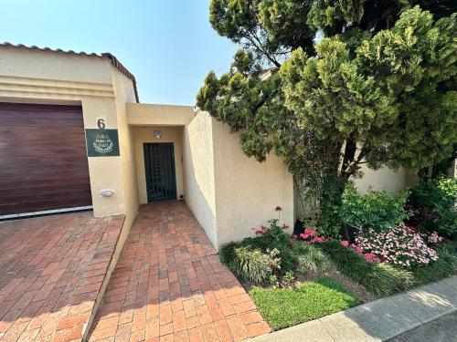 a house with a garage and a tree at Bobbie B's Kosher BnB in Johannesburg