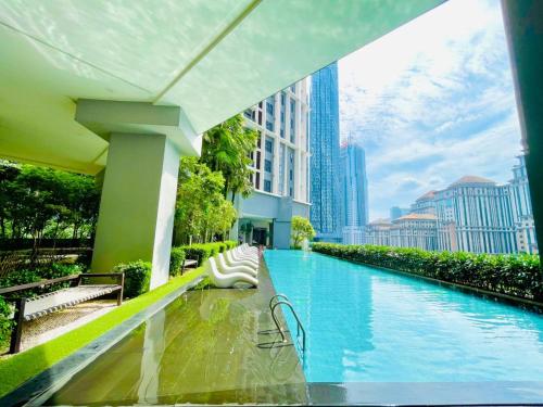 a swimming pool in a city with tall buildings at KLCC Sky Villa Suites The Mews in Kuala Lumpur