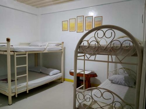 a room with two bunk beds in a room at Ravara Natividad Homestay in Lucap