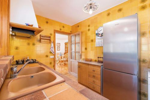a kitchen with a stainless steel refrigerator and a sink at Cozy Country House Banyols in Alaró