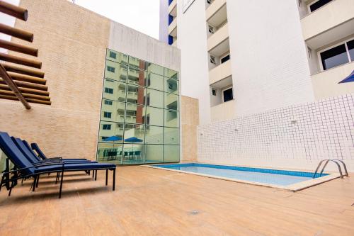 a patio with chairs and a swimming pool in a building at Go Inn Hotel Aracaju in Aracaju