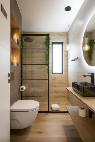 a bathroom with a white toilet and a sink at Cuencaloft Ático Encantado Deluxe con Terraza in Cuenca