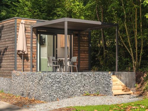 een kleine hut met een tafel en een parasol bij Tiny House | 2 personen in Tandel