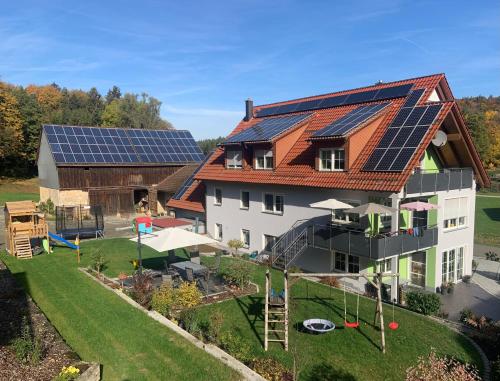 an image of a house with solar panels on the roof at Ferienwohnung Lahner in Königsfeld
