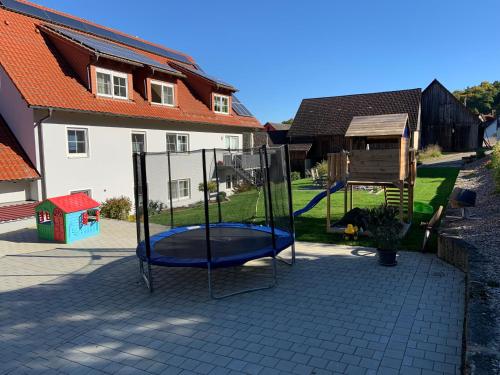 a playground in a yard next to a house at Ferienwohnung Lahner in Königsfeld