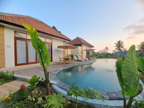 a villa with a swimming pool and a house at The Green Sidemen in Silebeng