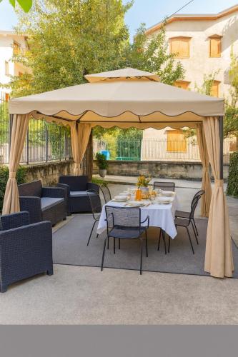 a gazebo with a table and chairs under it at Chalet Mary Roccaraso in Roccaraso