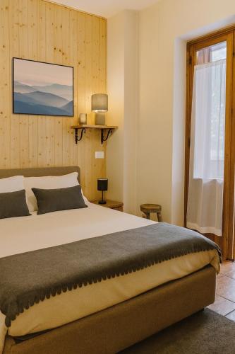a bedroom with a large bed and a window at Chalet Mary Roccaraso in Roccaraso