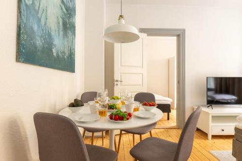 a dining room with a white table and chairs at Authentic Copenhagen Apartment for 4 Guests in Copenhagen