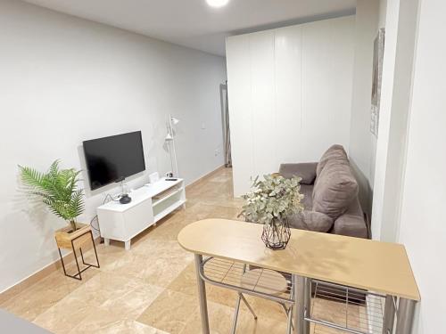 a living room with a couch and a table at Loft II Madueño de los Aires in Alcalá de Guadaira